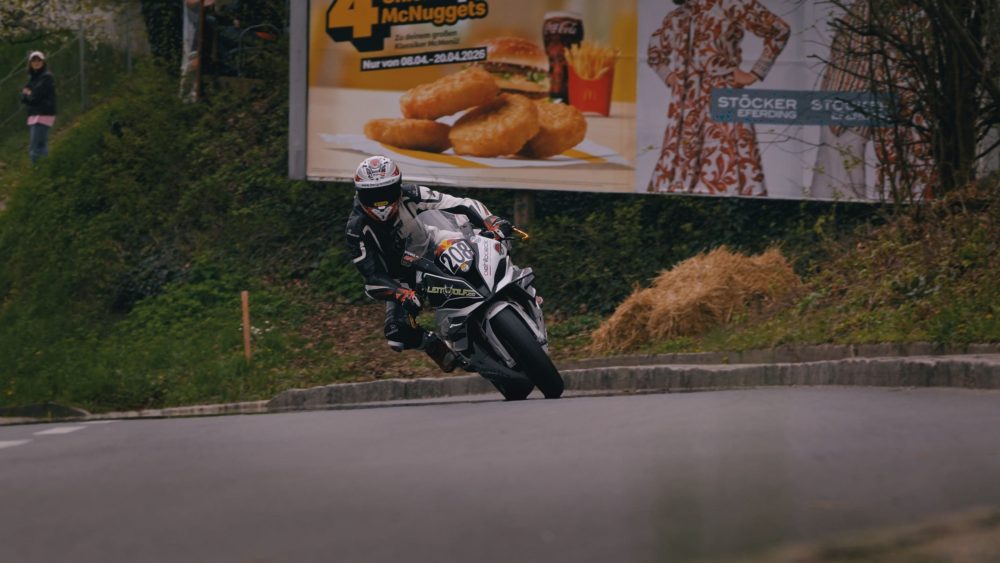 Landshaag Bergrennen 2026 | Oberösterreich Superbike in Schräglage vor Strohballen und Plakatwand beim Landshaag Bergrennen 2026