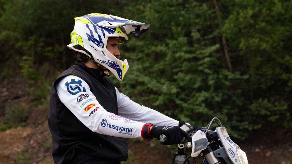 Husqvarna Fahrer mit einem Helm in Weiß und Gelb im Wald am Erzberg